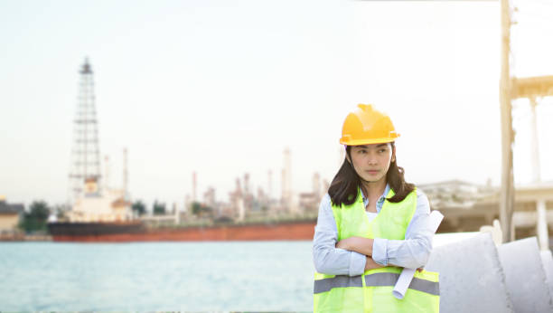 istock Engineering wearing yellow helmet and working at construction site about transportation of international logistics background 1077957318