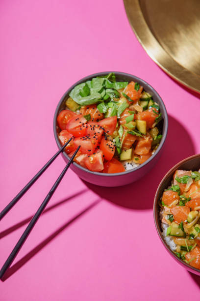 istock Poke bowl with marinated salmon and vegetable salad on rice 1077958132