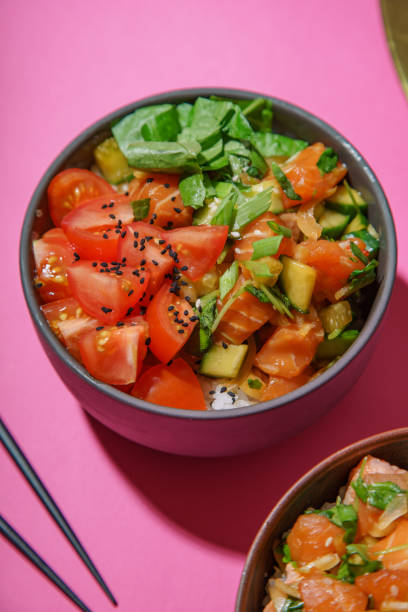 istock Poke bowl with marinated salmon and vegetable salad on rice 1077958142