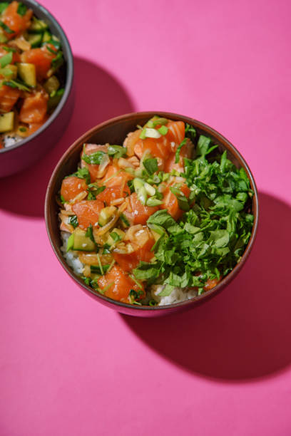 istock Poke bowl with marinated salmon and vegetable salad on rice 1077958158