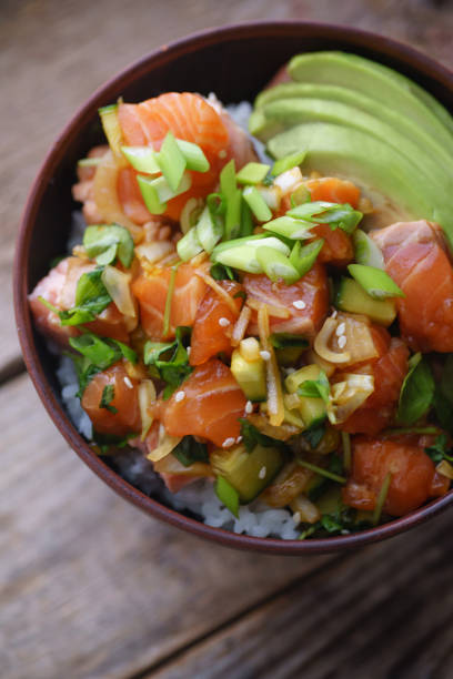 istock Poke bowl with raw marinated salmon, cucumbers and avocado. Macro shot 1077958164