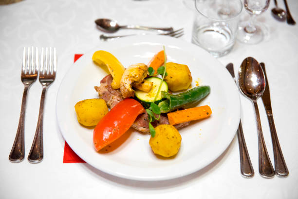 istock A portion of meat with vegetables on a decorated table 1077963812