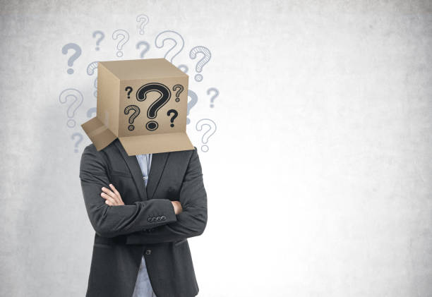 istock Businessman with a box on his head, question marks 1077965848
