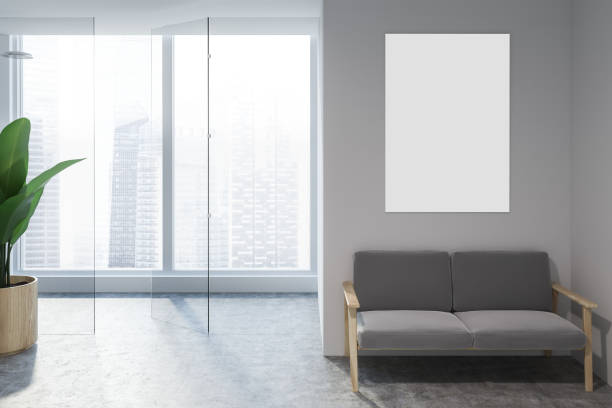 istock White living room with gray sofa and poster 1077965944