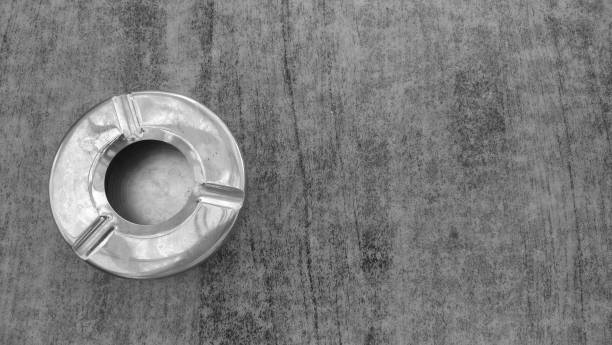 istock Steel metal empty ashtray on a gray table. View from above 1077966412