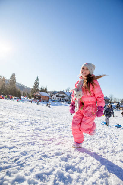 istock Cheerful Young Girl Running on Snow 1077966918