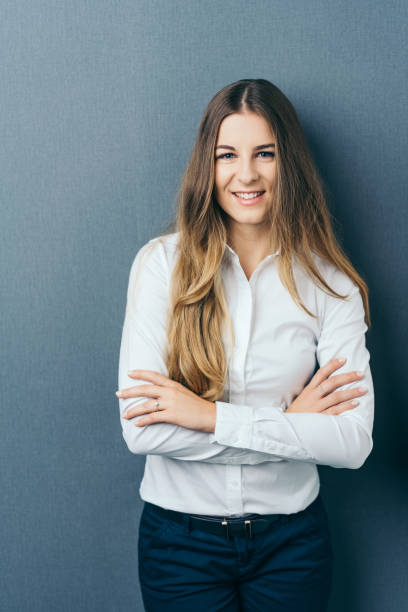 istock Relaxed confident young woman with folded arms 1077968268