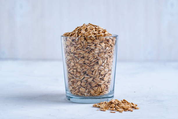 istock Glass of raw oatmeal on table 1077969548
