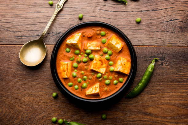 Green peas or matar paneer curry recipe, served in a bowl. selective focus stock photo
