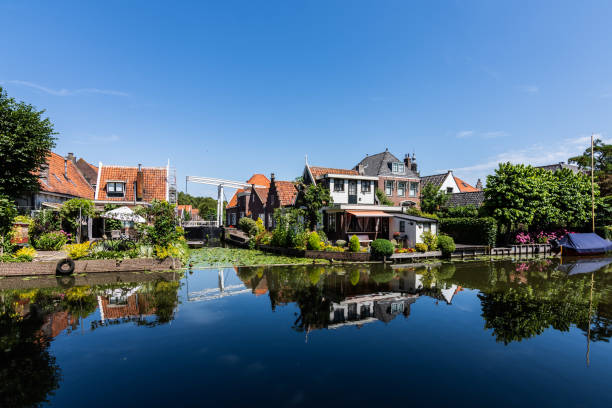 istock Edam's colorful houses reflected in the water, with a nice blue sky 1077980926