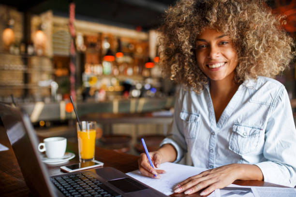 istock Focused young African woman working online in a cafe 1077981650