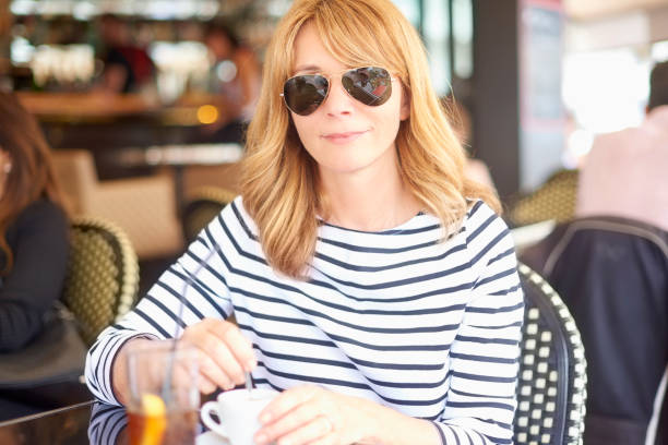 istock Attractive woman sitting at cafe 1077981866
