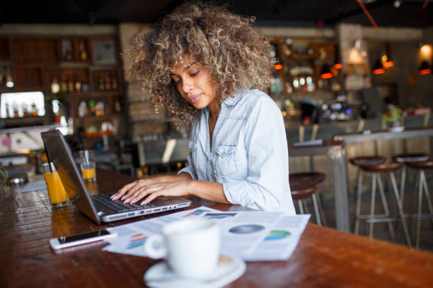 istock Focused young African woman working online in a cafe 1077982444