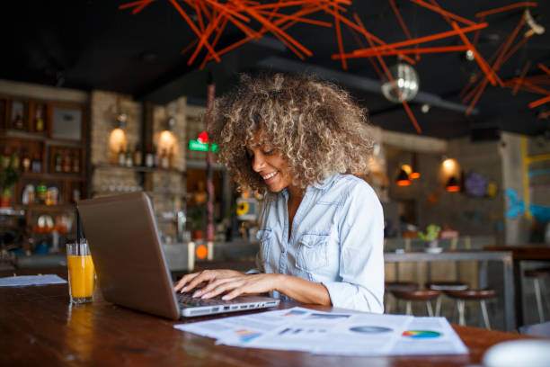 istock Focused young African woman working online in a cafe 1077986376