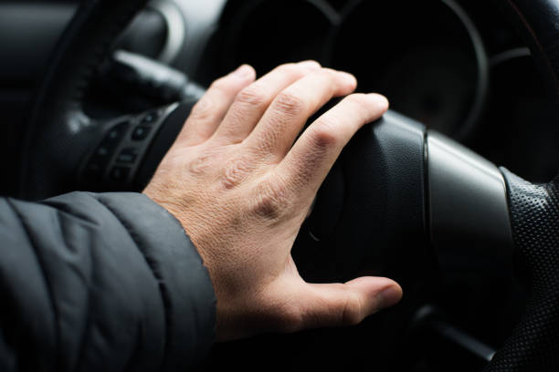 istock Hand on the steering wheel, close-up 1077990796