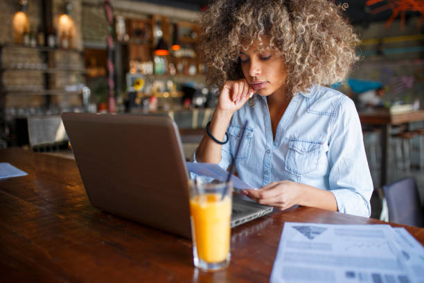 istock Focused young African woman working online in a cafe 1077991318