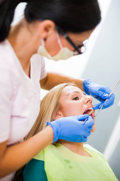istock Young woman at dentist 1077991716