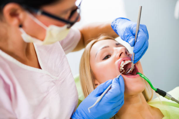 istock Young woman at dentist 1077993196