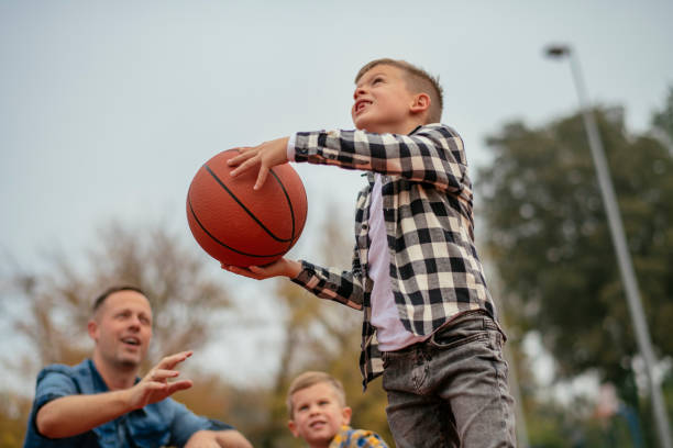 istock Father with his children playing basketball 1077994102