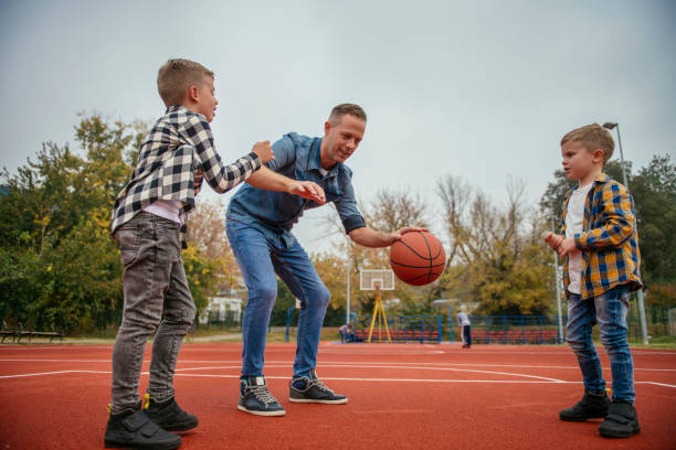 istock Father with his children playing basketball 1077994316