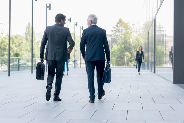 istock Businessmen walking together 1077996390