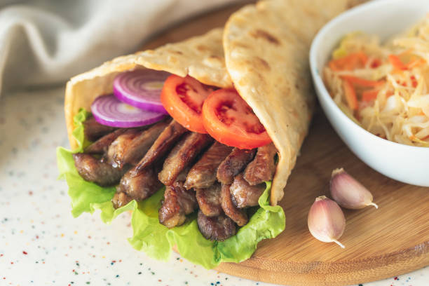 istock Handmade shawarma is lying on the white table made of artificial stone 1077996784