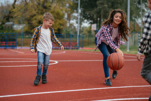 istock Family having fun time at basketball field 1077997968