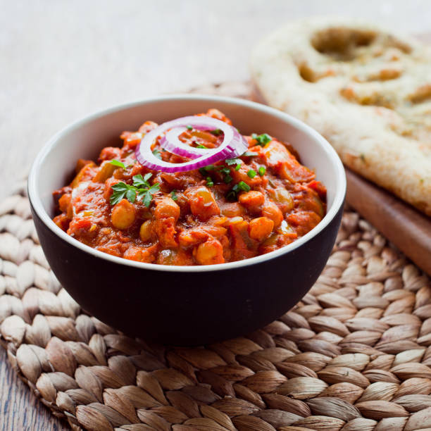 istock Chickpea Vegetarian Curry  -  Chana Masala with Naan Bread. 1077999196