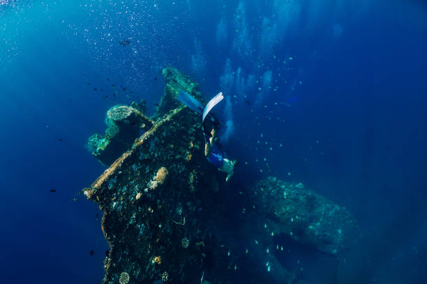 istock Free diver man dive at shipwreck, underwater 1077999762