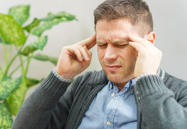 istock Handsome unshaved man having a headache at home. 1078001080