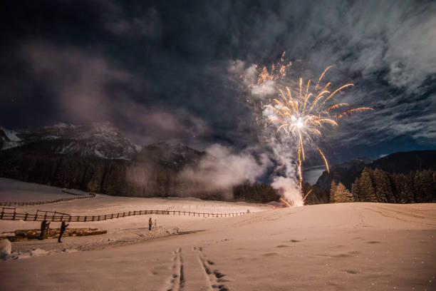 istock Firework for new year's eve in the mountains with some people whatching the explosions 1078007148