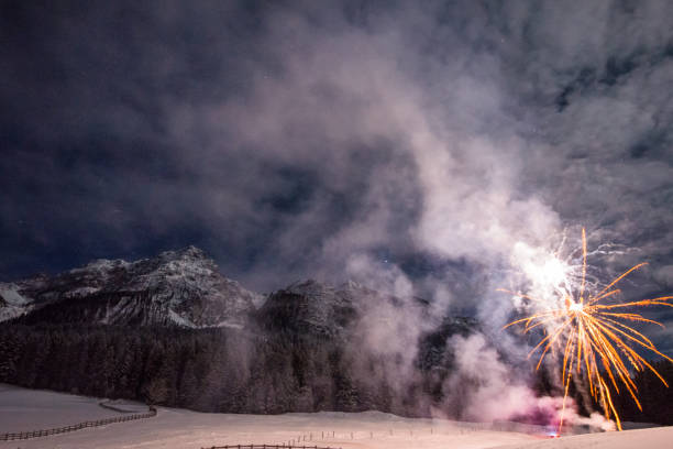 istock Firework for new year's eve in the mountains with some people whatching the explosions 1078008462