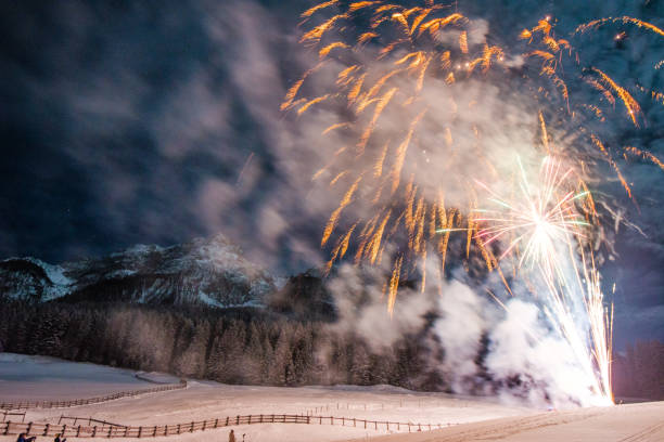istock Firework for new year's eve in the mountains with some people whatching the explosions 1078008492
