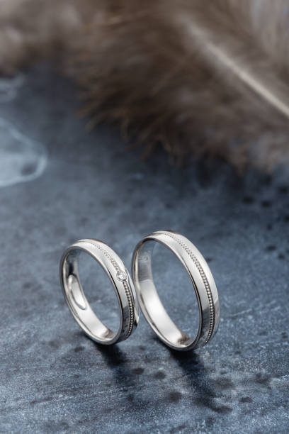 istock White gold or silver wedding rings on dark gray background 1078014480
