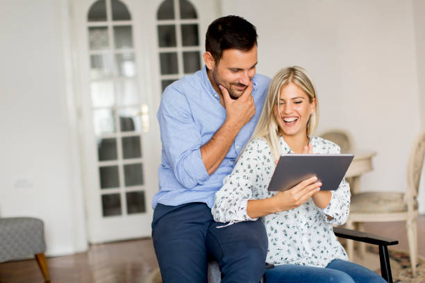 istock Young couple with tablet in the room 1078014636