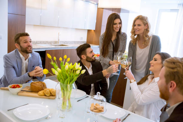 istock Young friends having dinner at home and toasting with white wine 1078020898