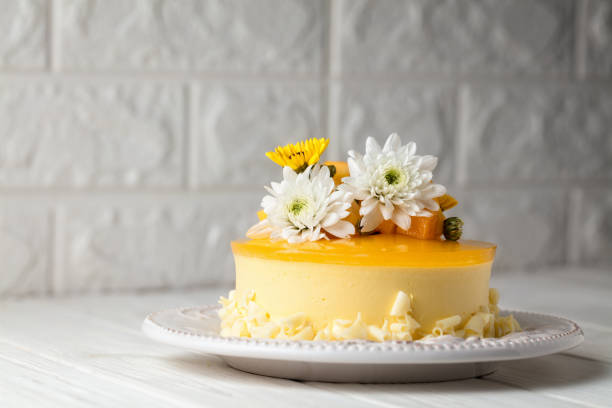 istock Glazed Mango cheesecake with flowers and fresh mango pieces on grey background, horizontal composition 1078023004