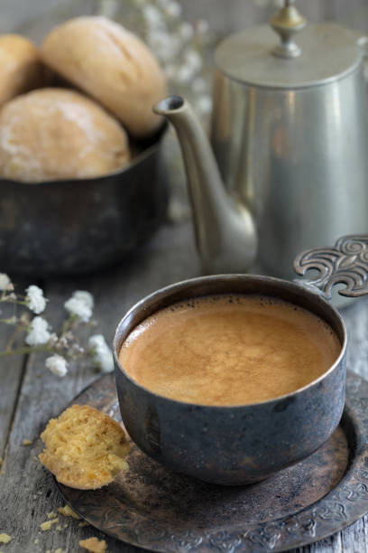 istock Cup of coffee, pot and cookie on wooden rustic background as a still life vertical composition 1078023036