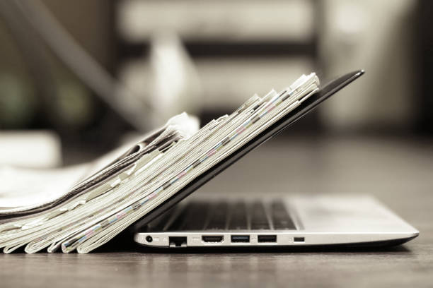 Newspapers and laptop