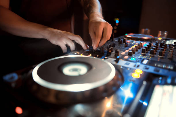 istock DJ mixing music on console at the club 1078024640