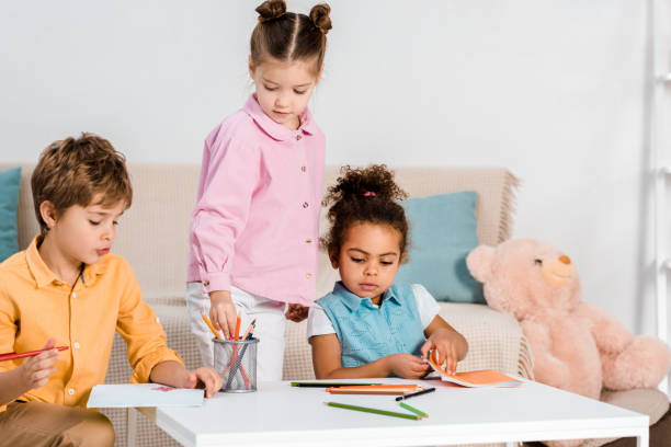 istock adorable multiethnic children drawing and studying together 1078027654