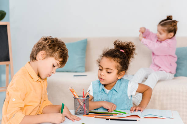 istock adorable multiethnic children drawing with pencils 1078027660