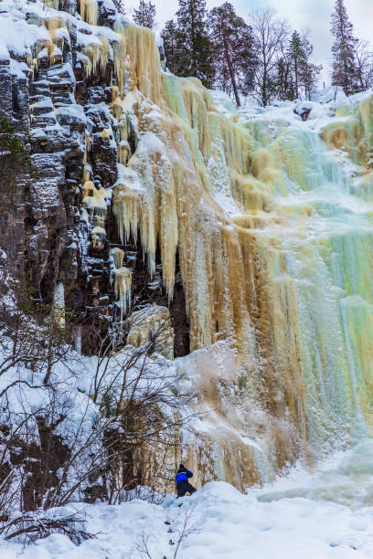 istock Man climbs to frozen waterfall 1078027964