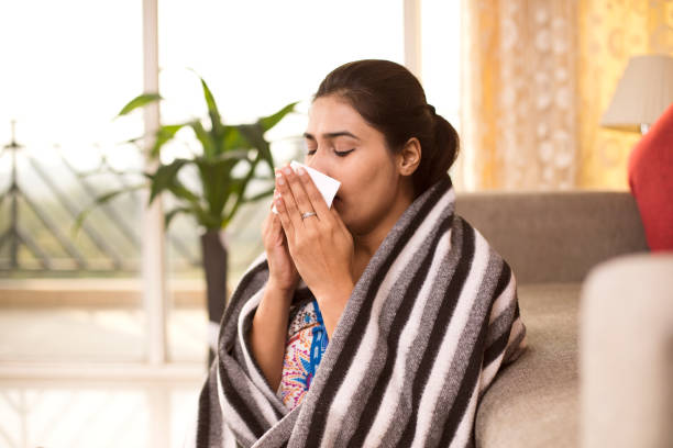 istock Sick woman blowing her nose 1078029370