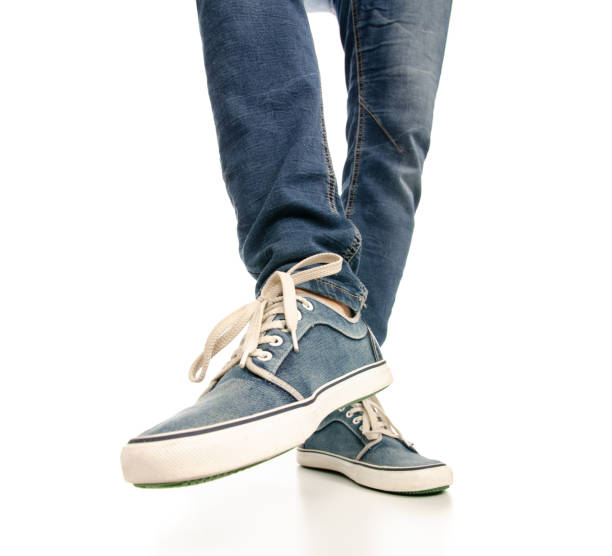 istock Man legs feet jeans sneakers 1078031596