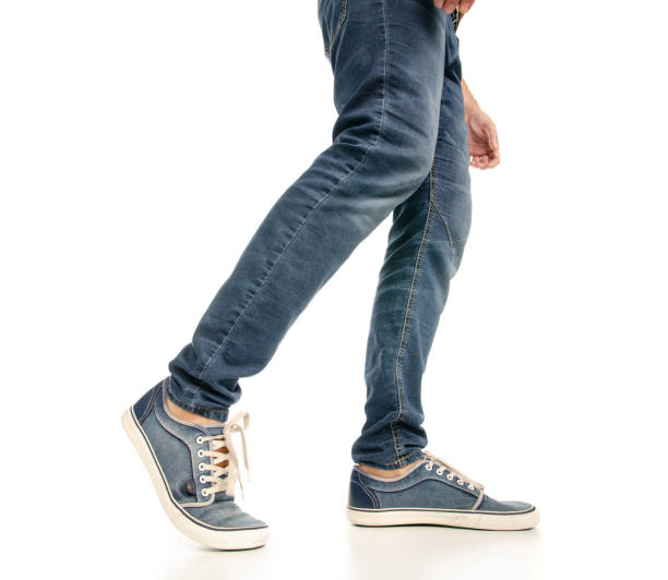 istock Man legs feet jeans sneakers 1078031752