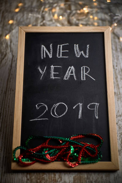 istock Black chalkboard with the written words NEW YEAR 2019 1078031788