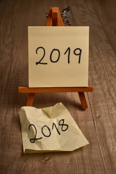 istock easel with yellow leaves written with the new year 2019 1078031852