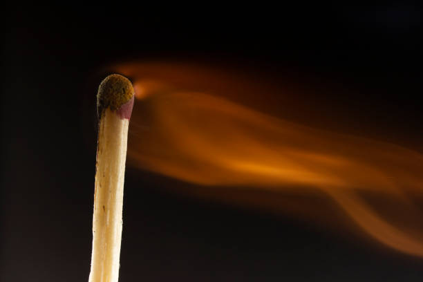 istock Burning wooden match with a red match head on a black background. 1078033860