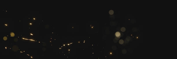 istock blurred sparks from christmas lights in front of black backgound 1078039392